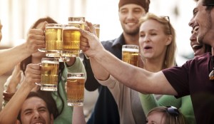 Young people at bistro having beer