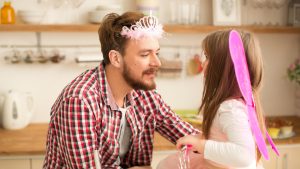 Father and daughter baking in kitchen.