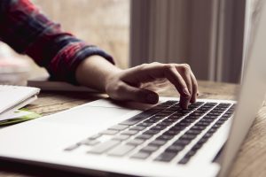 Close up teenage girl using laptop computer